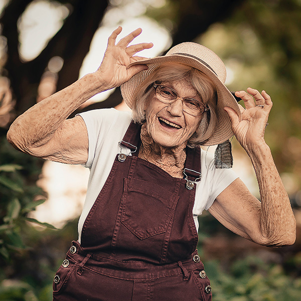 elderly lady smiling with straw hat | HR support